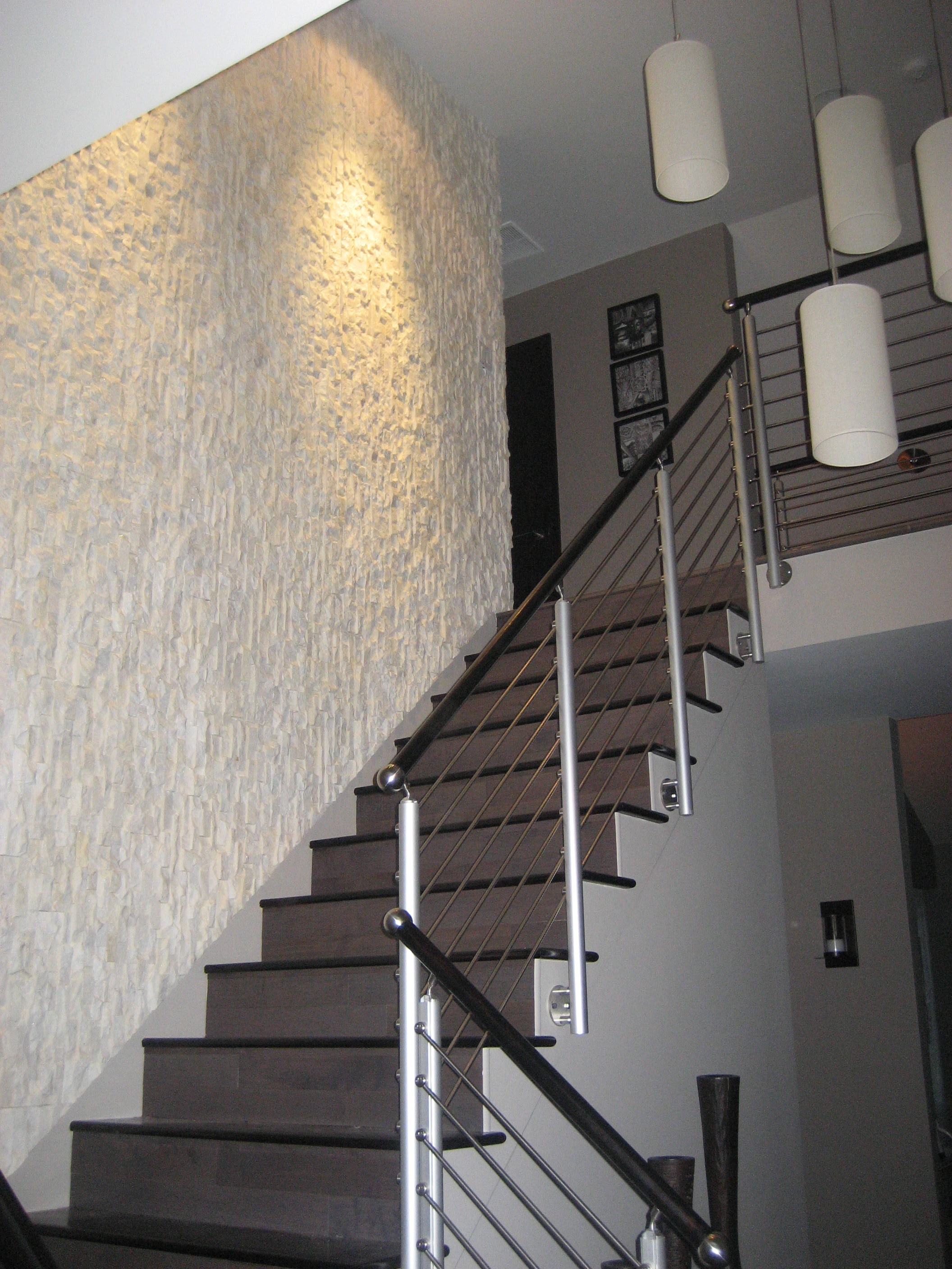 Norstone Stacked Stone White Rock Panels run vertically on stair case